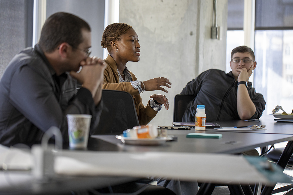 Three participants brainstorm how to approach the weekend's main objective. (Credit. Sean McNeil)