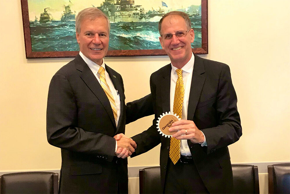 President Bud Peterson presents a coaster to Dave Sienicki