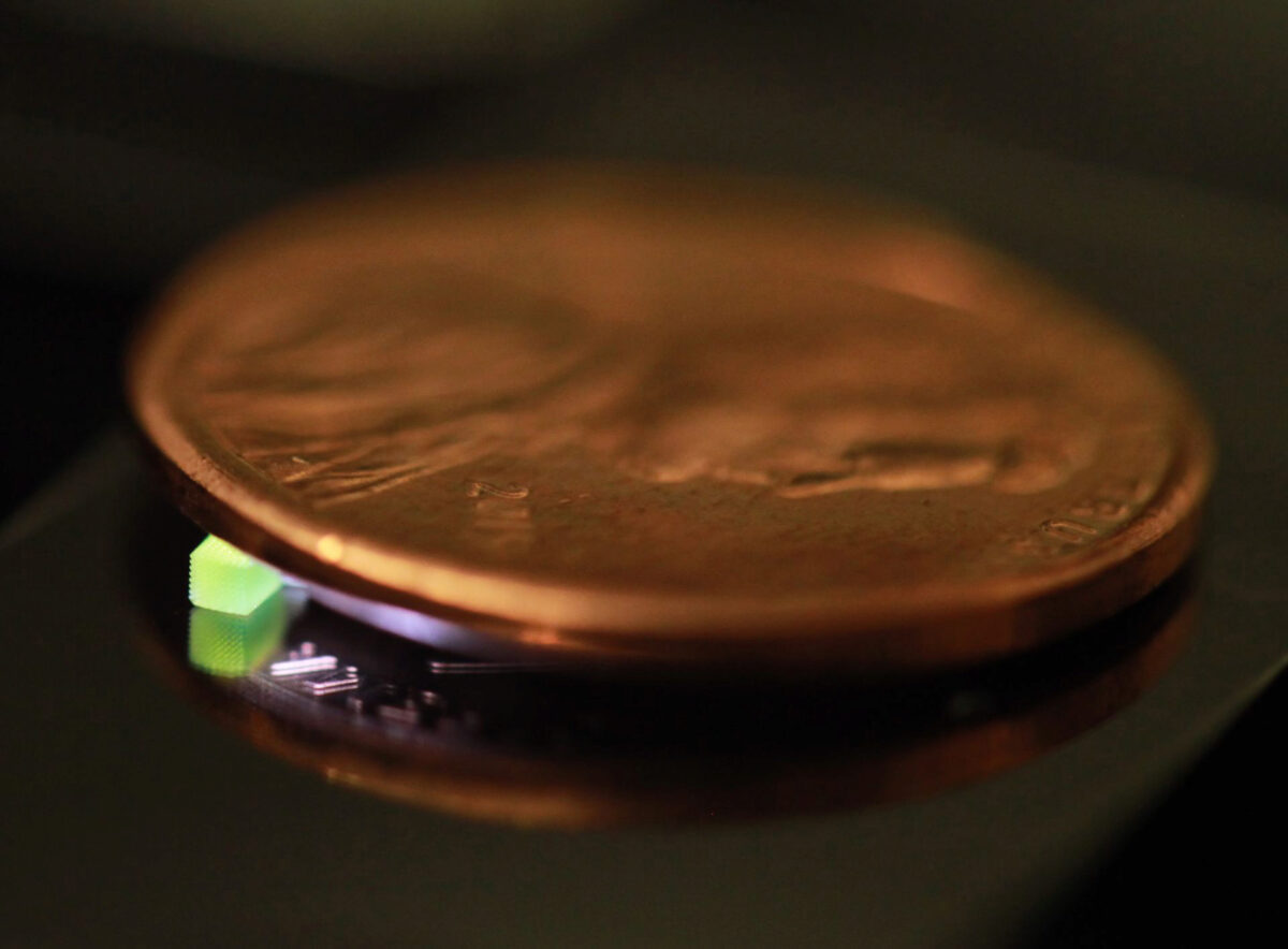 A millimeter-scale structure with submicron features is supported on a U.S. penny on top of a reflective surface. (Credit: Vu Nguyen and Sourabh Saha)