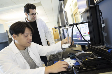 Associate Professor Costas Arvanitis and mechanical engineering Ph.D. student Hohyun "Henry" Lee 