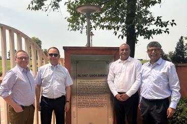 David Bridges, Bernard Kippelen, Devesh Ranjan, and Shreyes Melkote visiting Raj Ghat in India.